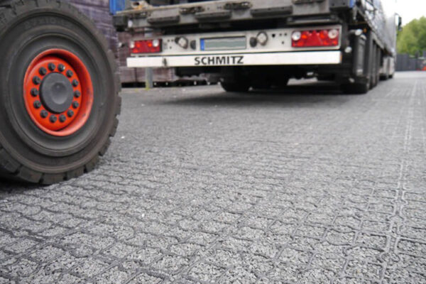 Nahaufnahme einer Schotter befüllten ECORASTER Fläche mit LKW
